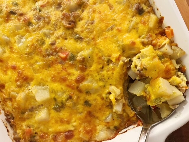 This sausage and potato breakfast casserole is so good and is great for a crowd! It's filled with tender potatoes, cheese, diced peppers, and ground sausage.